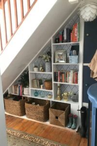 Under stair shelves with books, ornaments and baskets